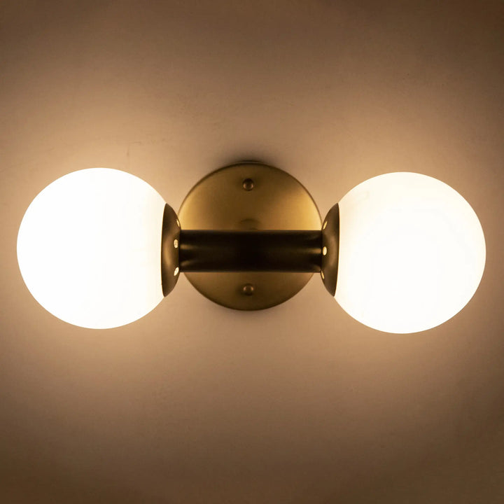 American Home Furniture | Noir - Antiope Sconce, Antique Brass and Glass