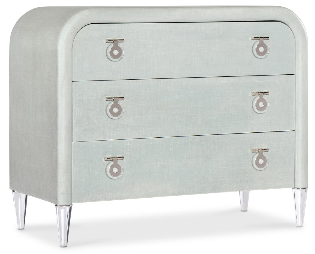 Light seafoam green linen exterior with clear acrylic legs and silver chrome-colored metal accents. Hardware is clear acrylic and chrome-colored metal drop pulls.